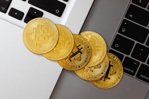 Gold Bitcoin on a laptop: the importance of KYC for cryptocurrency exchanges.