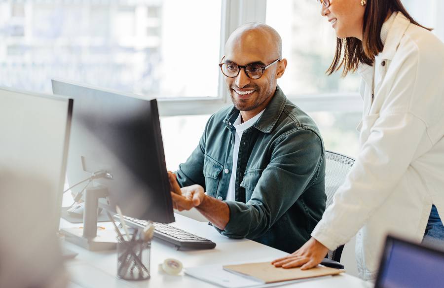 A male employee looking at his computer screen